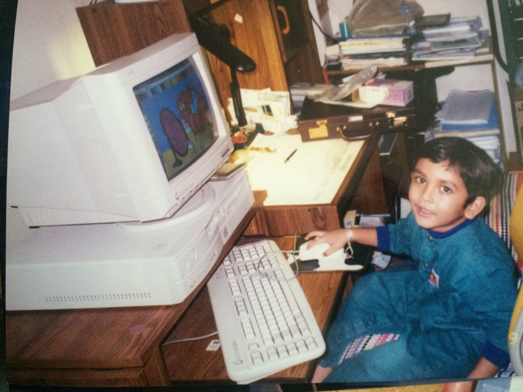 Childhood photo of Bhaumik at a desktop computer
